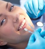 young-woman-selecting-tooth-colour-e1513773831918